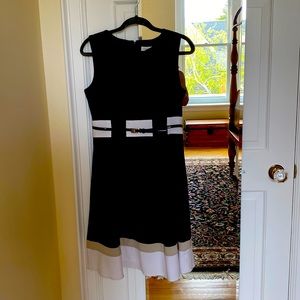 Sleeveless black and white dress with taupe stripe at hem